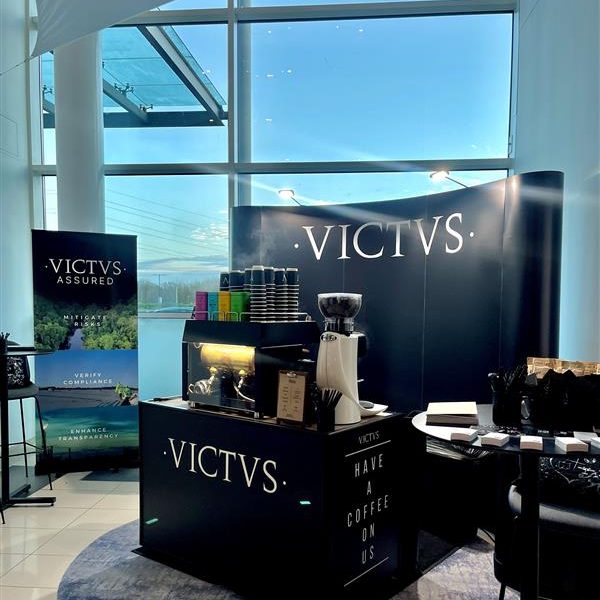 The VICTVS stand at the FAB 2024 conference and event, featuring a black banner and black fronted coffee bar.